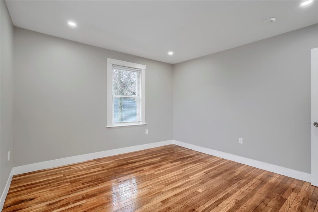 25 Patterson Street Boston, MA 02124 - Photo 23 of 32 a view of empty room with wooden floor and fan