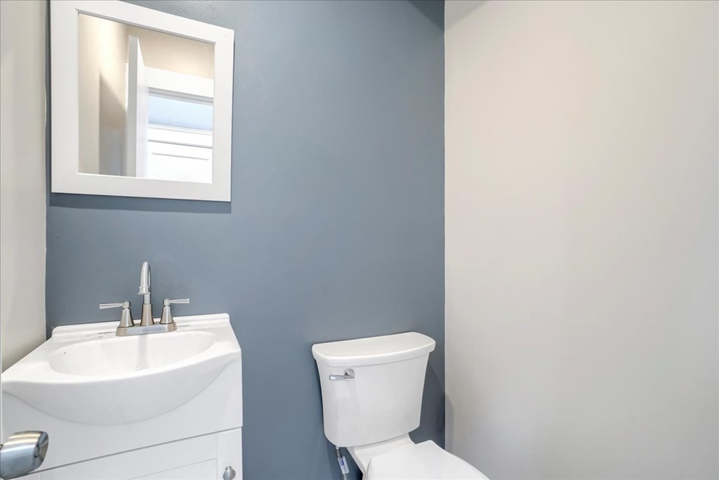 25 Patterson Street Boston, MA 02124 - Photo 24 of 32 a bathroom with a toilet sink and mirror