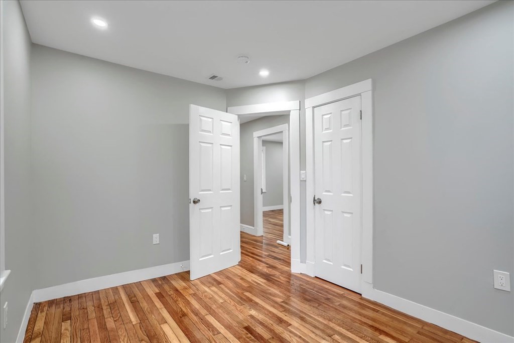 25 Patterson Street Boston, MA 02124 - Photo 27 of 32 a view of hallway with wooden floor