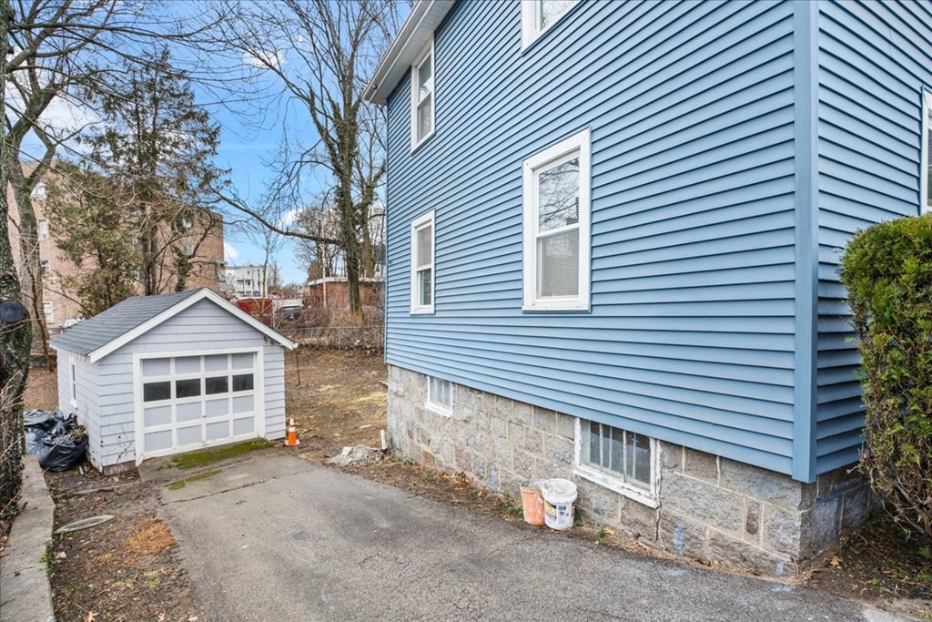 25 Patterson Street Boston, MA 02124 - Photo 32 of 32 a view of a house with a yard and garage