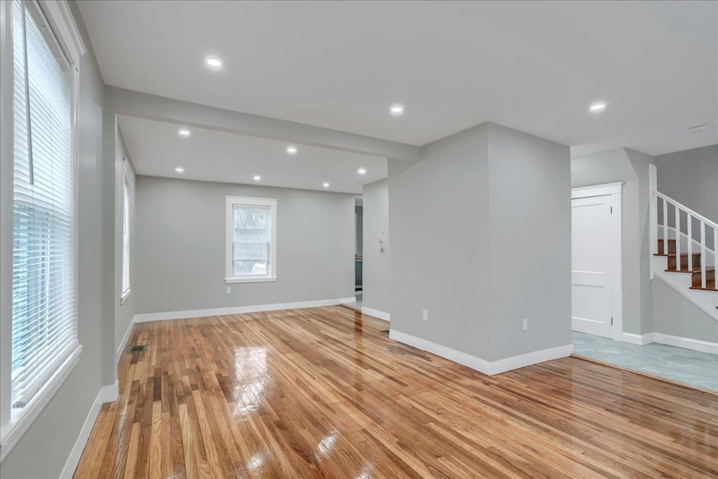 25 Patterson Street Boston, MA 02124 - Photo 6 of 32 a view of empty room with wooden floor and fan