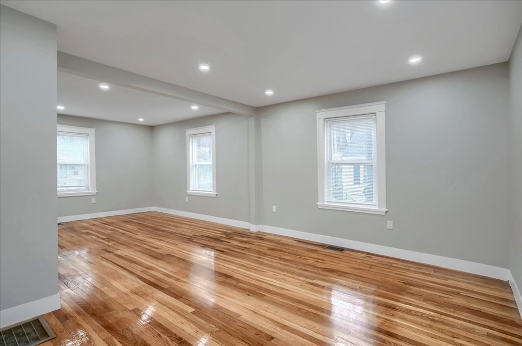 25 Patterson Street Boston, MA 02124 - Photo 7 of 32 a view of an empty room with wooden floor and a window