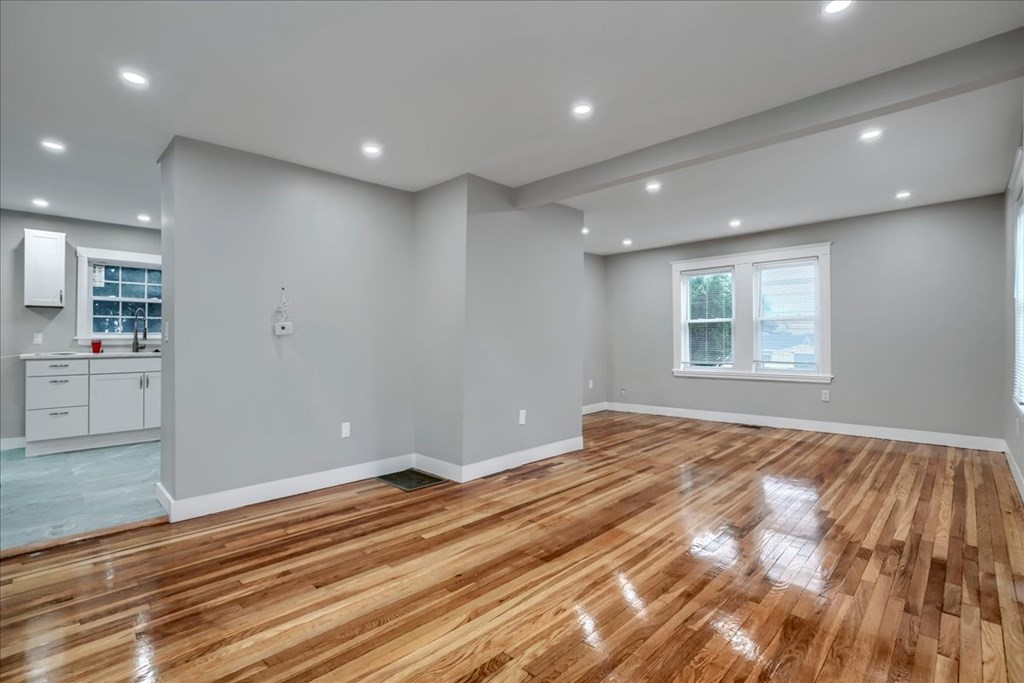 25 Patterson Street Boston, MA 02124 - Photo 8 of 32 a view of an empty room with wooden floor and a window