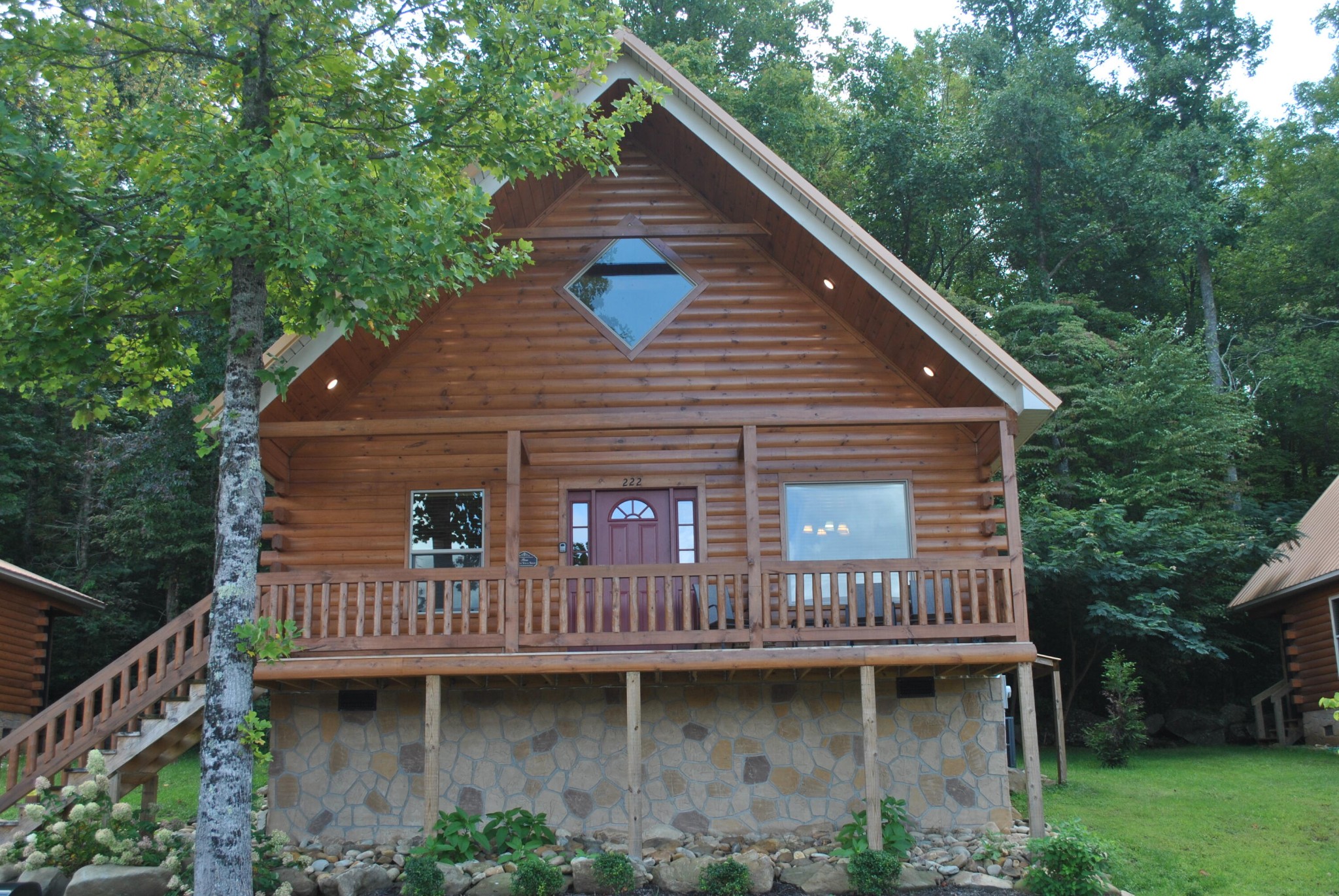 a view of a house with wooden deck and a garden