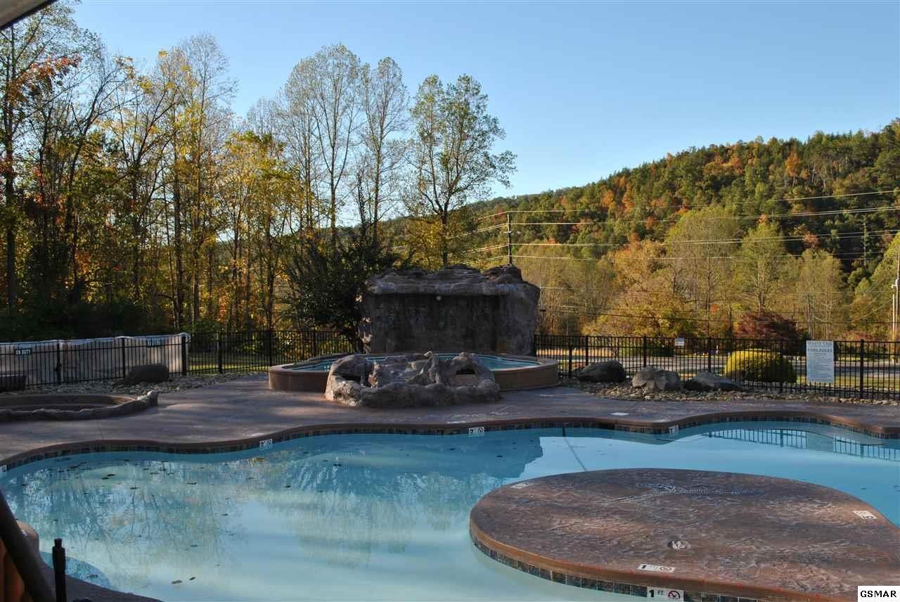 222 Forrest Loop Way Gatlinburg, TN 37738 - Photo 15 of 17 a view of a patio with table and chairs with wooden floor and fence