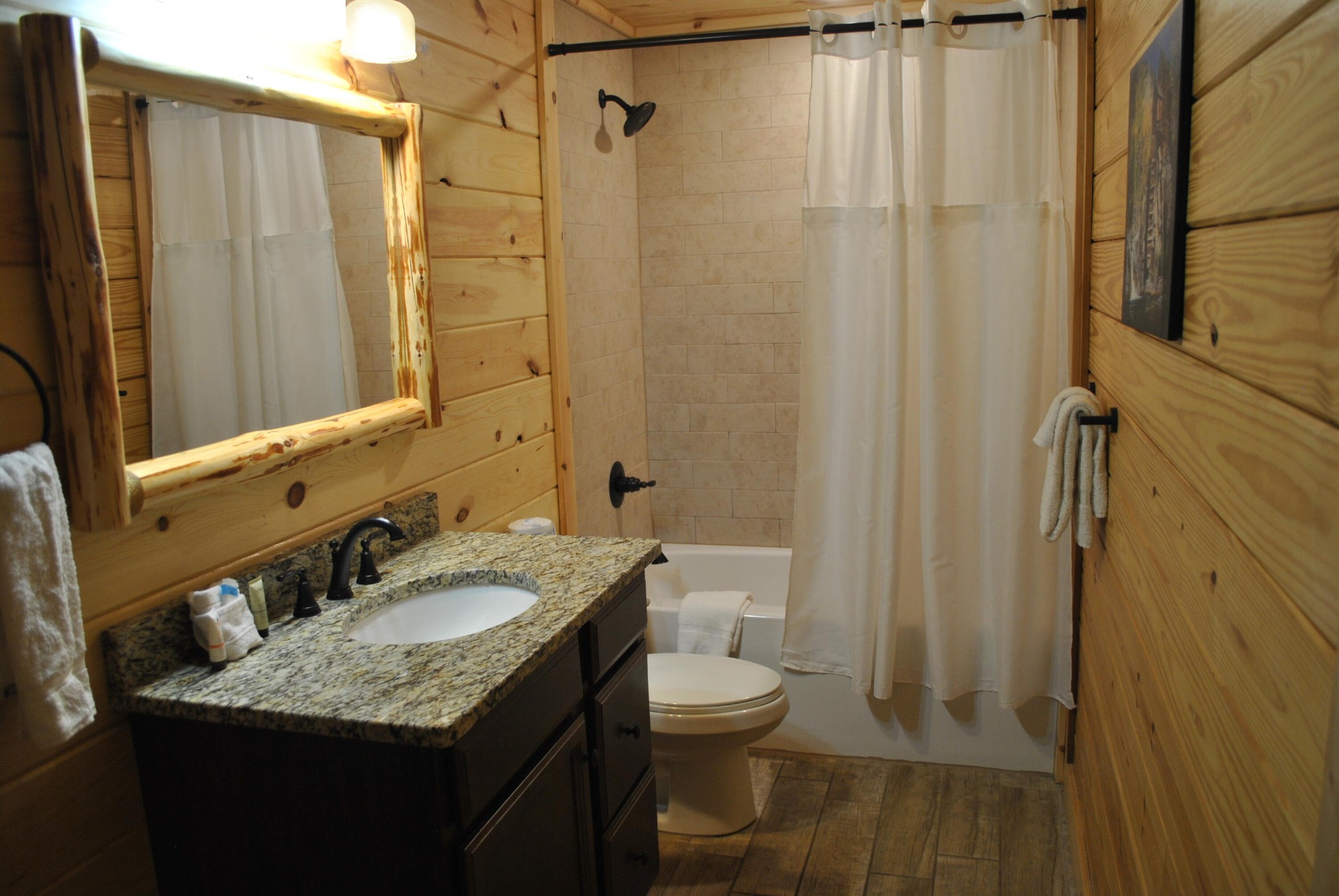 222 Forrest Loop Way Gatlinburg, TN 37738 - Photo 7 of 17 a bathroom with a granite countertop sink toilet and shower