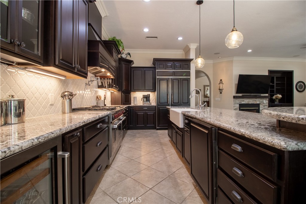 33699 Spring Brook Circle Temecula, CA 92592 - Photo 21 of 83 a kitchen with stainless steel appliances granite countertop counter space a sink and a wooden floor