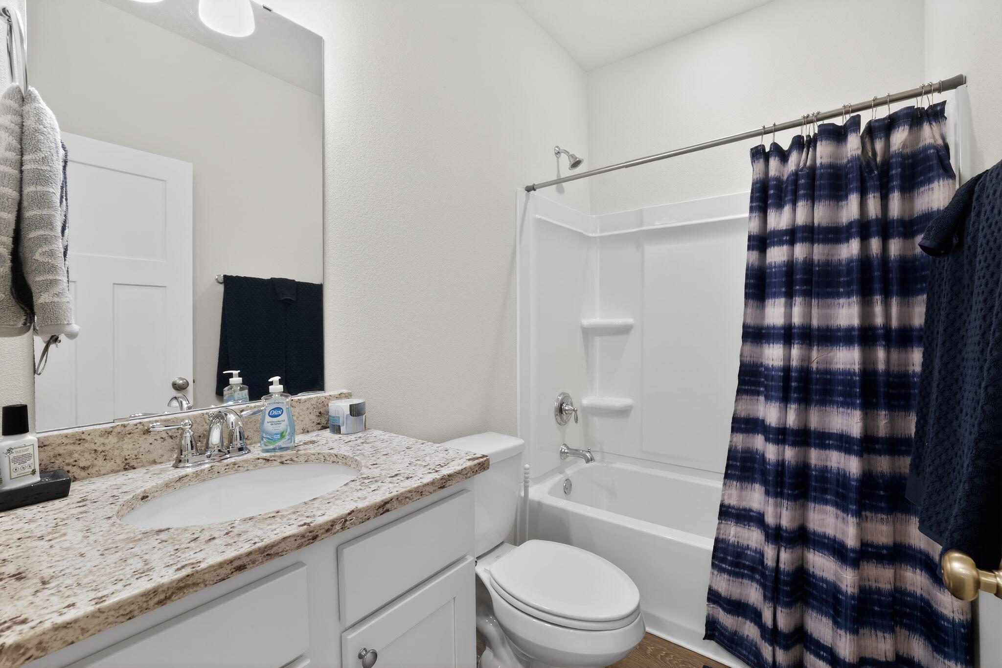 2452 Dakota Way Crestview, FL 32536 - Photo 21 of 24 a bathroom with a granite countertop sink toilet a shower and a mirror
