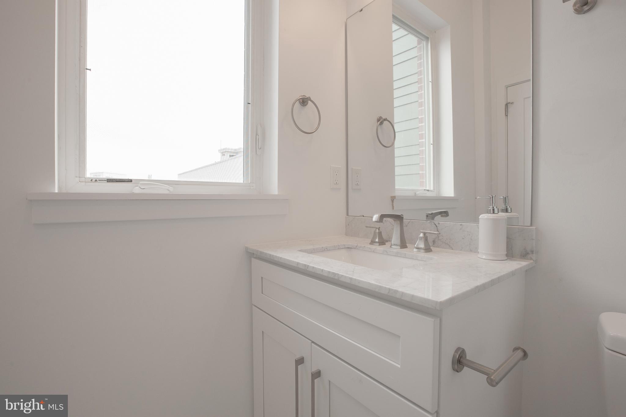 1534 Ridge Avenue, Unit 301 Philadelphia, PA 19130 - Photo 11 of 16 a bathroom with a sink and a mirror