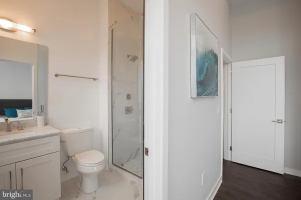 a bathroom with a toilet a sink and shower
