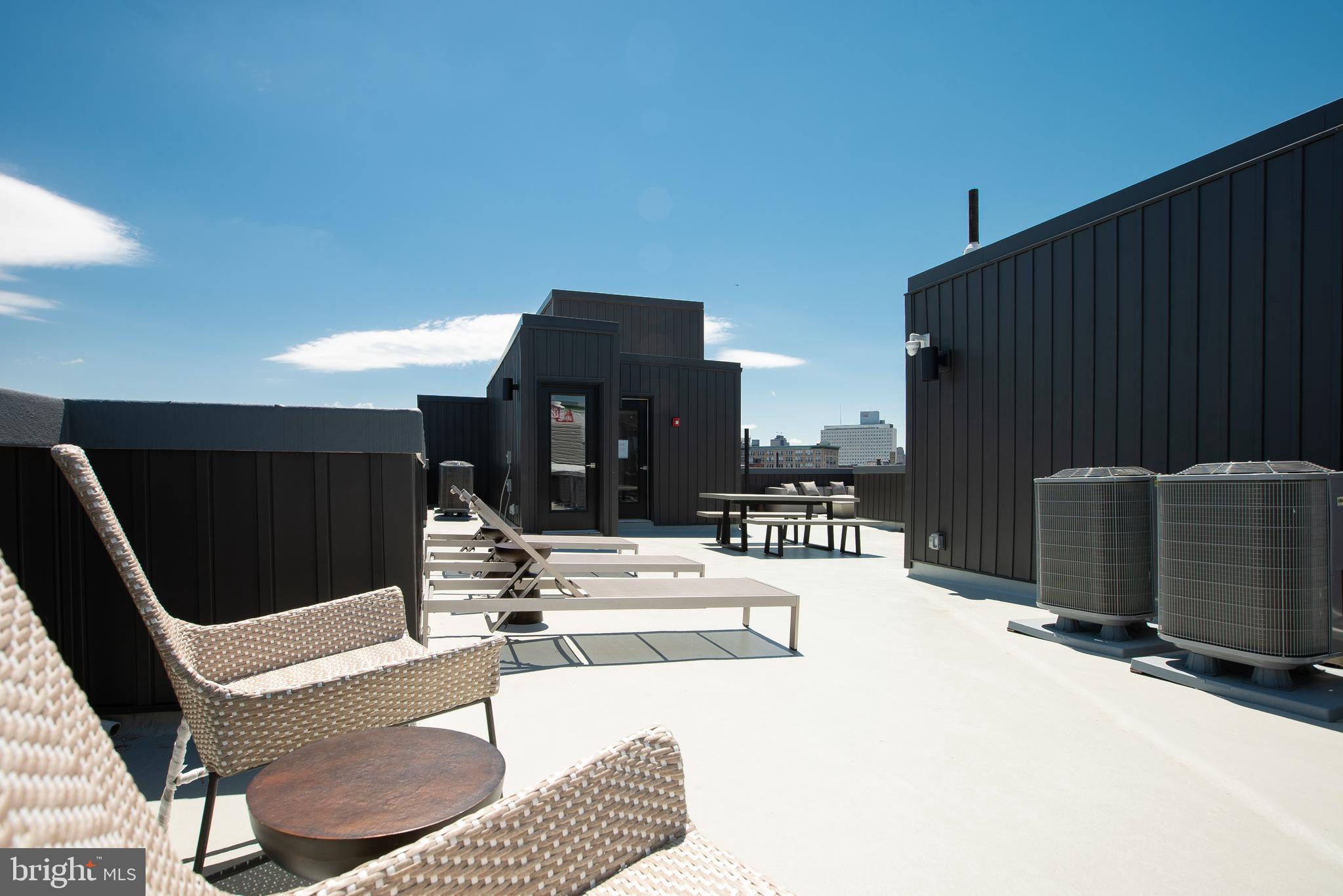 1534 Ridge Avenue, Unit 301 Philadelphia, PA 19130 - Photo 15 of 16 a view of a patio with table and chairs a barbeque