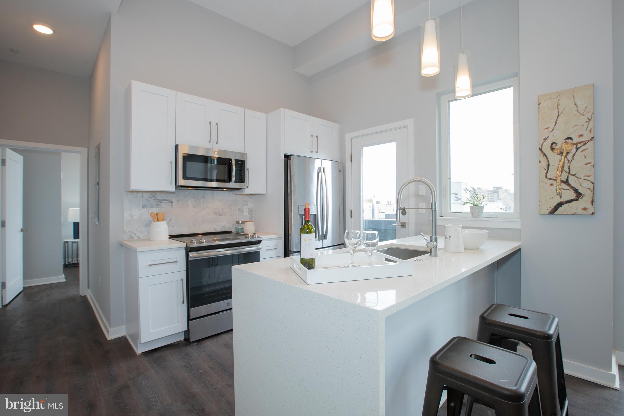 1534 Ridge Avenue, Unit 301 Philadelphia, PA 19130 - Photo 4 of 16 a kitchen with a sink stove and refrigerator