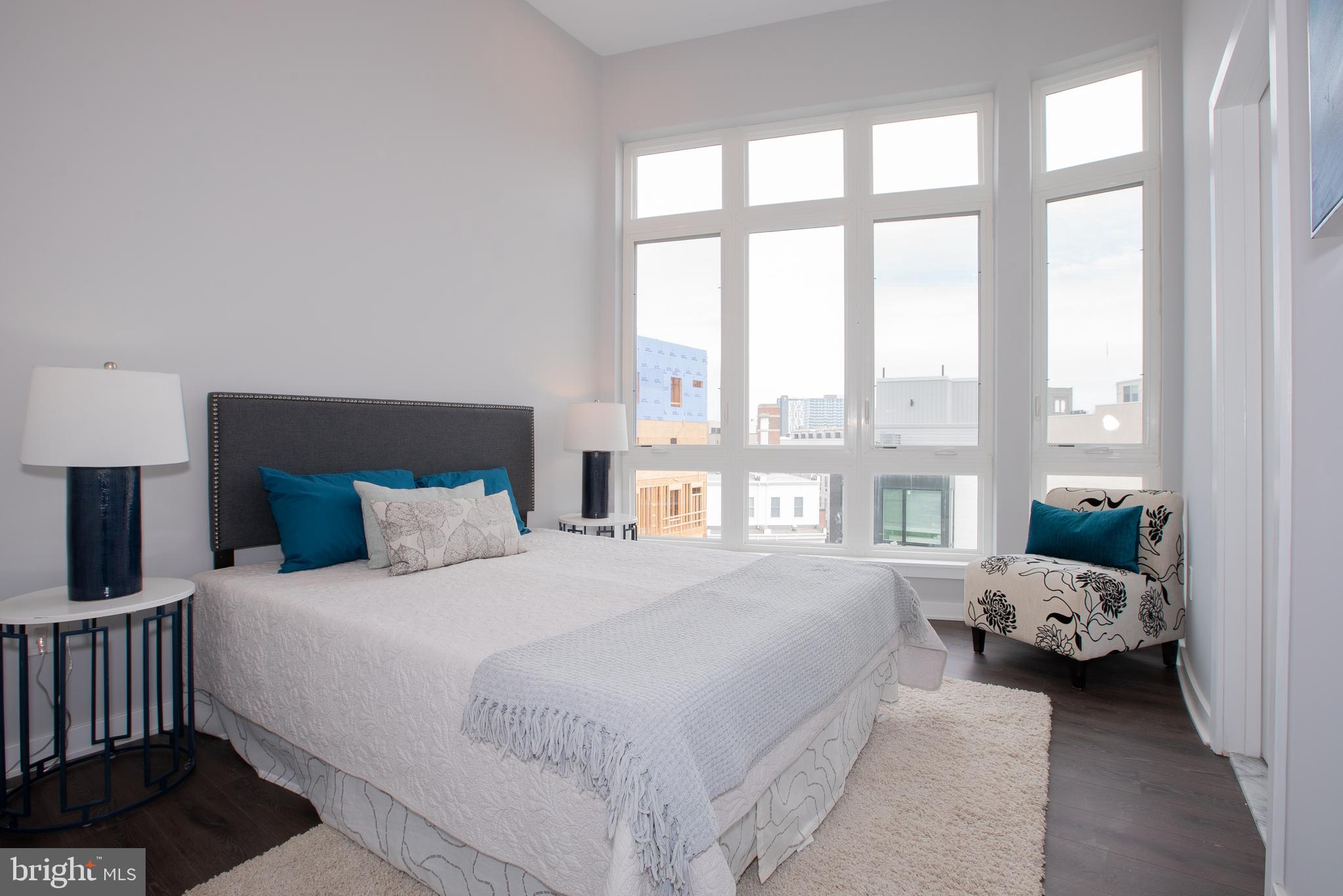 1534 Ridge Avenue, Unit 301 Philadelphia, PA 19130 - Photo 8 of 16 a bedroom with a bed couch and a large window