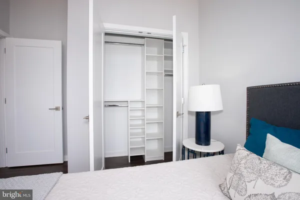 a bedroom with a bed and a lamp