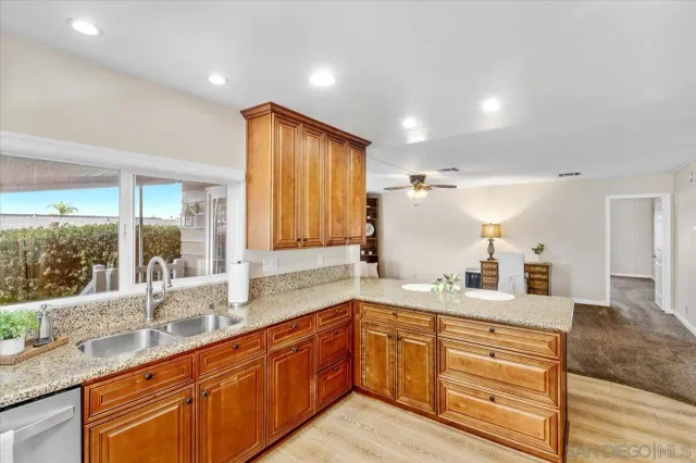 a bathroom with a granite countertop sink and a large mirror