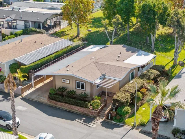 an aerial view of a house with garden space and street view