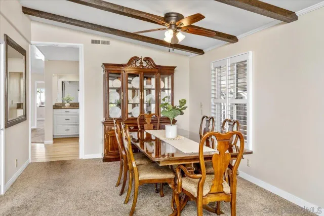 a view of a dining room with furniture and window
