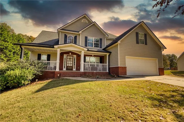 a front view of a house with a yard and garage