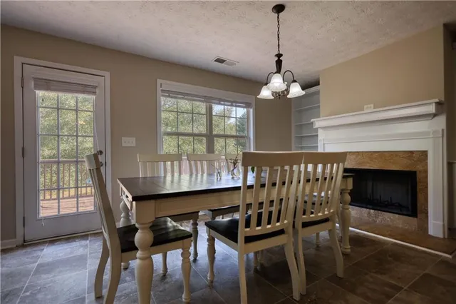 a dining room with furniture window and wooden floor