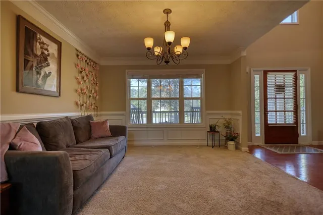 a spacious bedroom with a bed and wooden floor