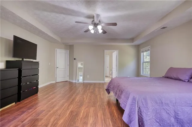 a en suite bathroom with a double vanity sink a mirror and a window