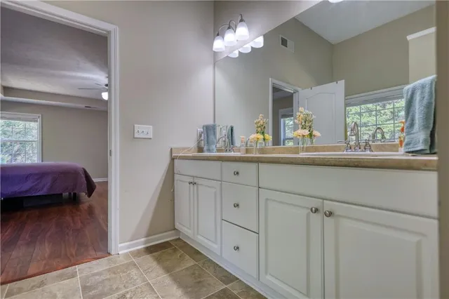a bathroom with a double vanity sink and a mirror
