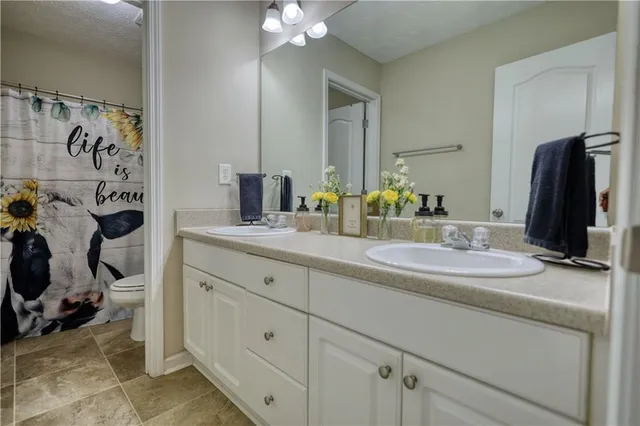 a white bath tub sitting in a bathroom next to a window