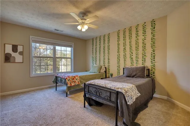 a bathroom with a toilet and a shower curtain
