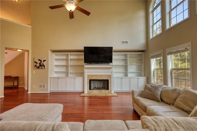 a living room with furniture fireplace and flat screen tv