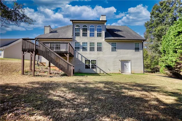 an aerial view of a house with a yard