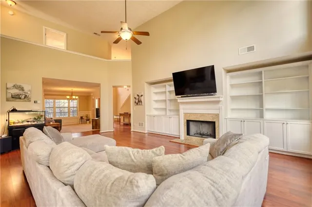 a living room with furniture a fireplace and a flat screen tv