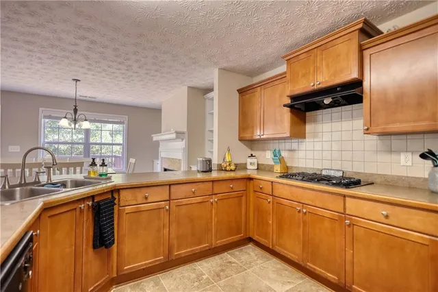 a kitchen with a sink stove and cabinets