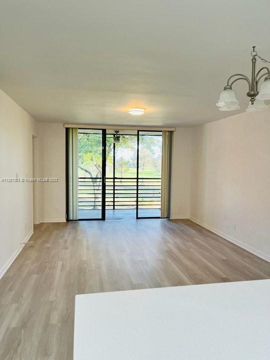 7950 West McNab Road, Unit 222 Tamarac, FL 33321 - Photo 12 of 35 wooden floor in an empty room with a window