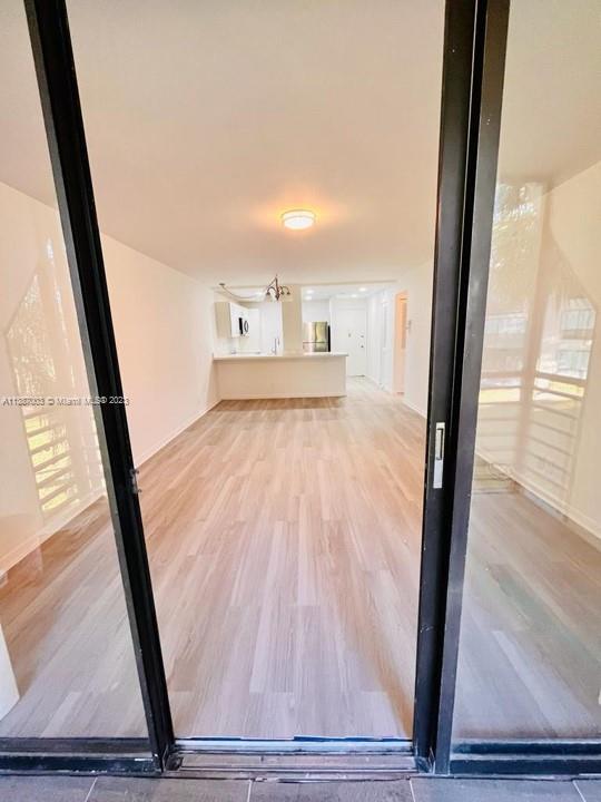 7950 West McNab Road, Unit 222 Tamarac, FL 33321 - Photo 13 of 35 a view of a room with wooden floor and door