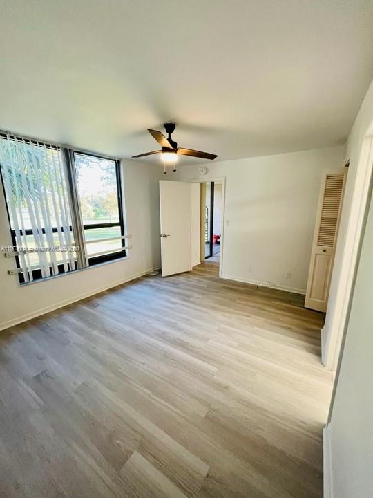 7950 West McNab Road, Unit 222 Tamarac, FL 33321 - Photo 18 of 35 wooden floor in an empty room with a window