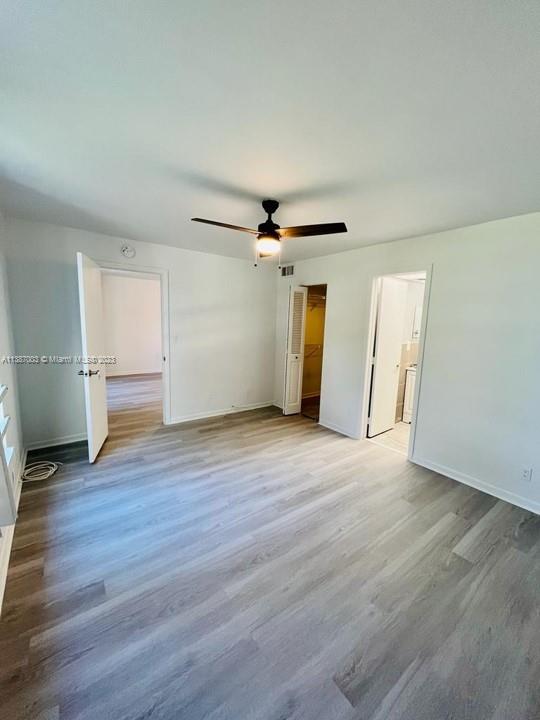 7950 West McNab Road, Unit 222 Tamarac, FL 33321 - Photo 19 of 35 an empty room with wooden floor and windows