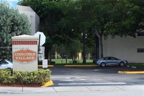 7950 West McNab Road, Unit 222 Tamarac, FL 33321 - Photo 2 of 35 a view of street with parked cars