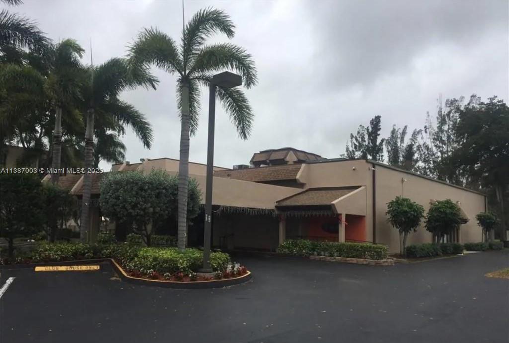 7950 West McNab Road, Unit 222 Tamarac, FL 33321 - Photo 28 of 35 a front view of a house with a garden and lake view