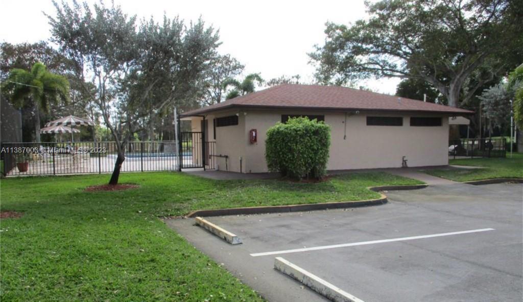 7950 West McNab Road, Unit 222 Tamarac, FL 33321 - Photo 30 of 35 a view of a house with a yard