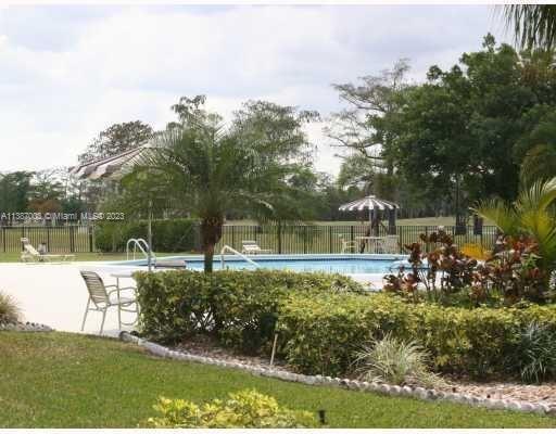 7950 West McNab Road, Unit 222 Tamarac, FL 33321 - Photo 31 of 35 a view of a house with a yard