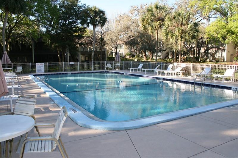 7950 West McNab Road, Unit 222 Tamarac, FL 33321 - Photo 32 of 35 a view of a swimming pool with a patio