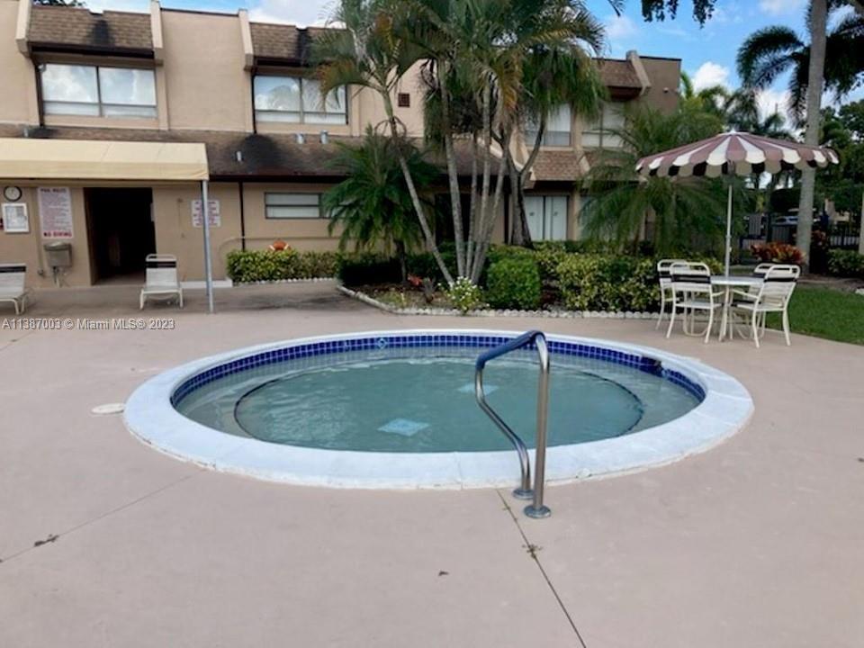 7950 West McNab Road, Unit 222 Tamarac, FL 33321 - Photo 33 of 35 a view of a swimming pool with a patio