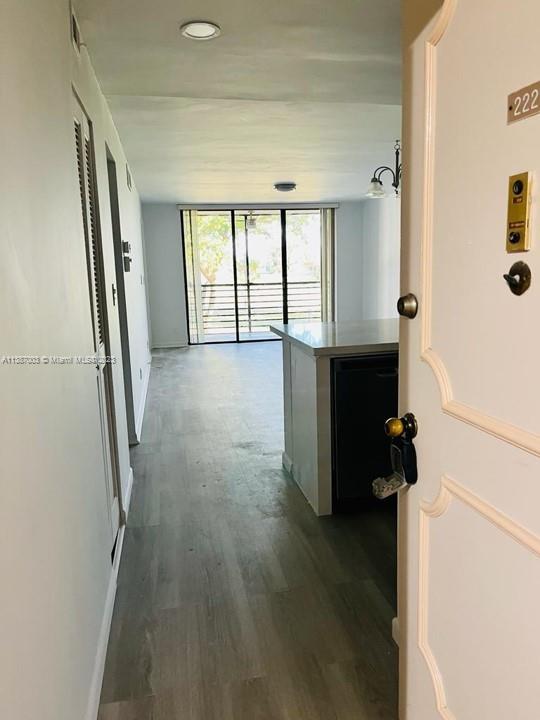 7950 West McNab Road, Unit 222 Tamarac, FL 33321 - Photo 5 of 35 a view of hallway with stairs and wooden floor