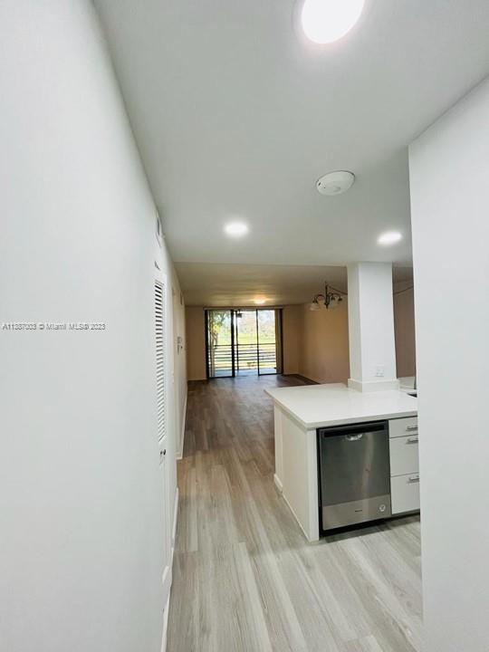 7950 West McNab Road, Unit 222 Tamarac, FL 33321 - Photo 6 of 35 a view of kitchen and empty room with wooden floor