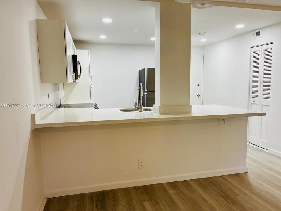 7950 West McNab Road, Unit 222 Tamarac, FL 33321 - Photo 9 of 35 a bathroom with a sink and a mirror