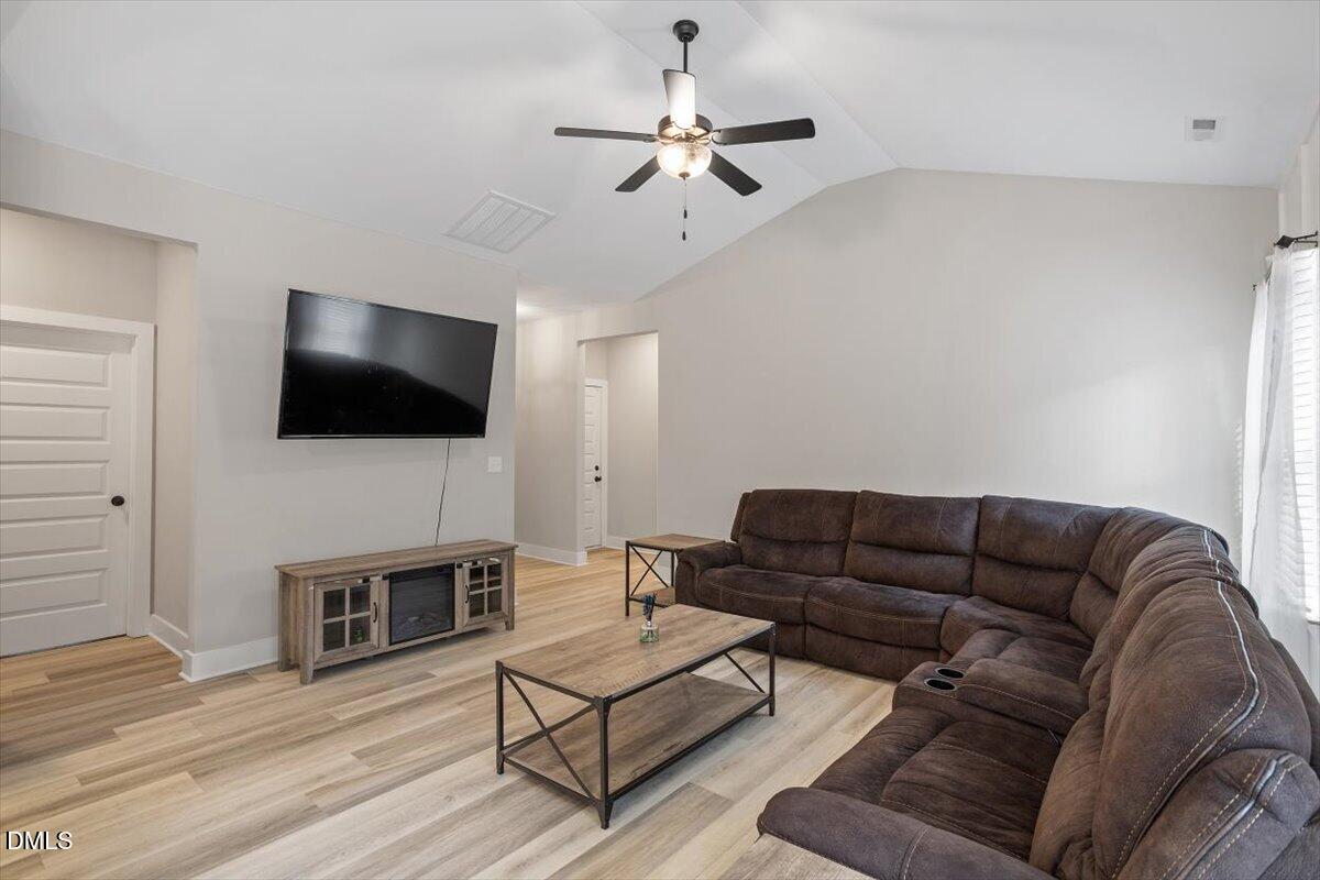 2810 Antioch Church Road Timberlake, NC 27583 - Photo 13 of 34 a living room with furniture and a flat screen tv