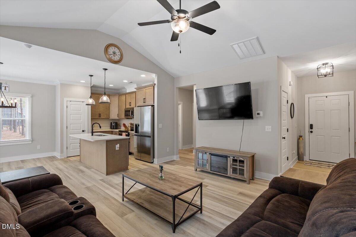 2810 Antioch Church Road Timberlake, NC 27583 - Photo 14 of 34 a living room with furniture and a flat screen tv