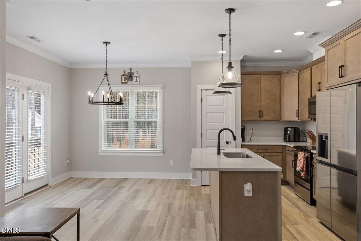 2810 Antioch Church Road Timberlake, NC 27583 - Photo 15 of 34 a kitchen with kitchen island granite countertop a sink cabinets stainless steel appliances and a window