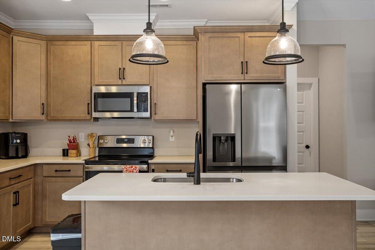 2810 Antioch Church Road Timberlake, NC 27583 - Photo 17 of 34 a kitchen with stainless steel appliances a stove microwave and refrigerator