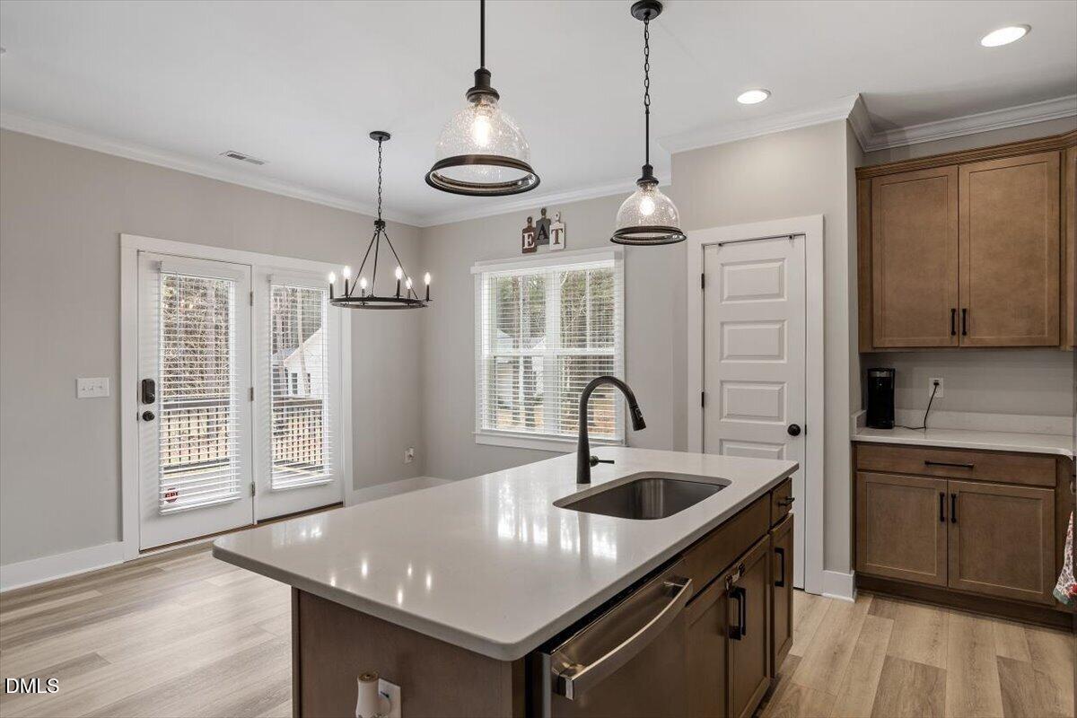 2810 Antioch Church Road Timberlake, NC 27583 - Photo 20 of 34 a kitchen with a center island a sink stainless steel appliances and cabinets
